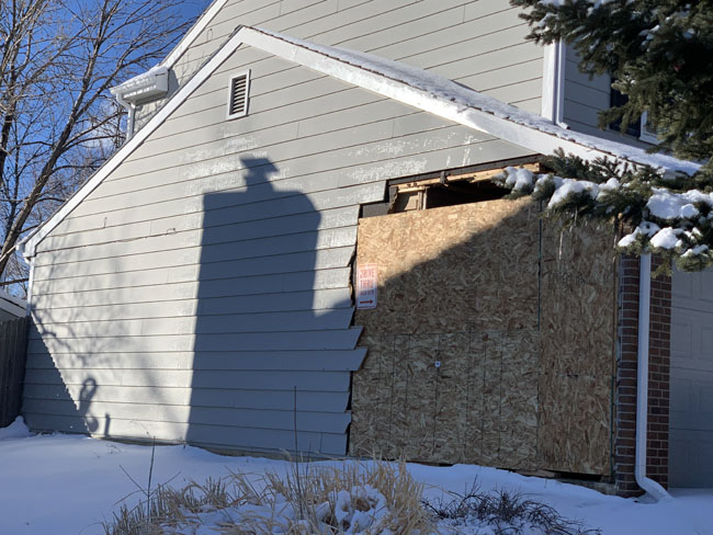 Boarded up home after vehicle impact